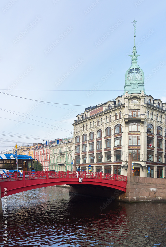 Saint Petersburg. The view from the embankment of the Moika River to Red Bridge (Krasny Most) on Gorokhovaya Street and the spire of Esders Trading House