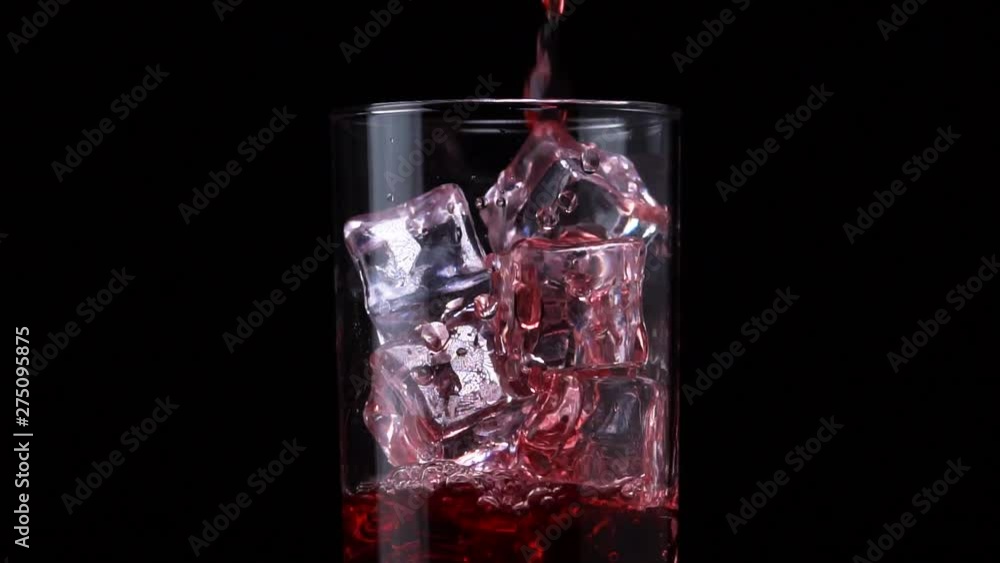 Close-up A Berry Juice Or Alcohol Drink Is Poured Into A Glass Close-up A Berry Juice Or Alcohol Drink Is Poured Into A Glass