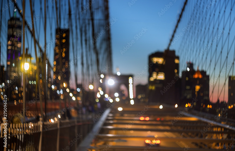 Blurred urban traffic Brooklyn Bridge at twilight in New York City background scene at night