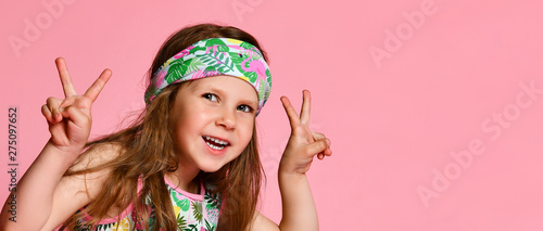 Slika na platnu Portrait of happy cheerful girl in summer dressing for hair, showing peace gestu