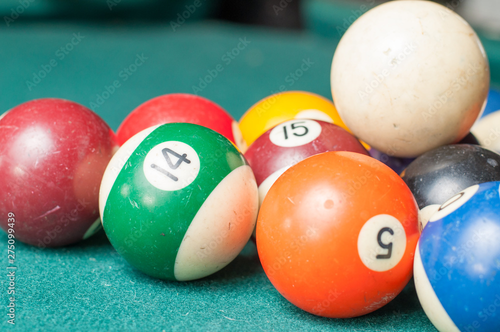 Old billiard balls on a green table. billiard balls isolated on a green background Old billiard balls on a green table. billiard balls isolated on a green background