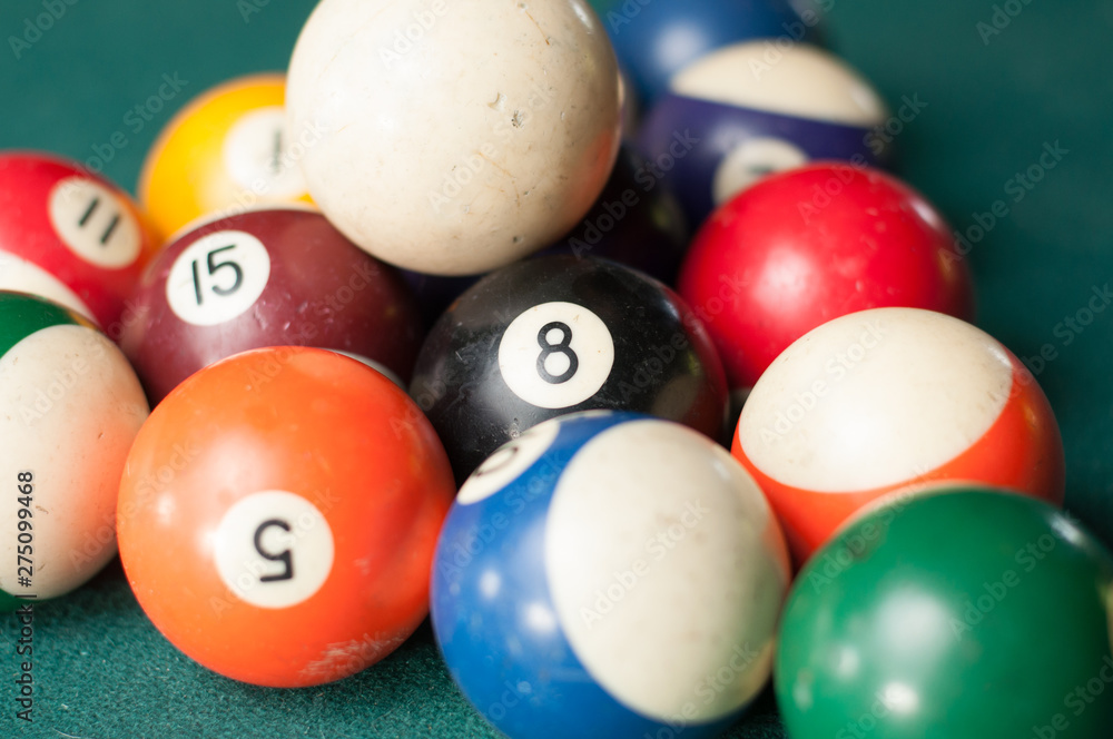 Old billiard balls on a green table. billiard balls isolated on a green background Old billiard balls on a green table. billiard balls isolated on a green background