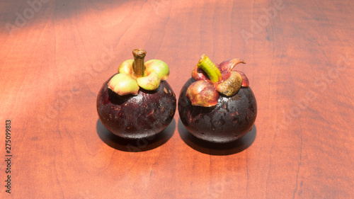 Tropical fruits mangosteen on the wooden table