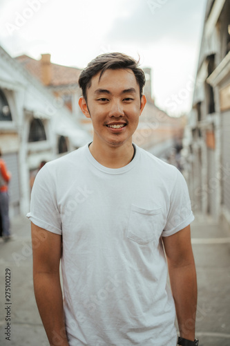 Portrait of a young Asian man at sunset in Venice, Italy