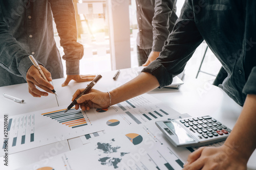 Business people analyzing investment graph meeting brainstorming and discussing plan in meeting room, investment concept