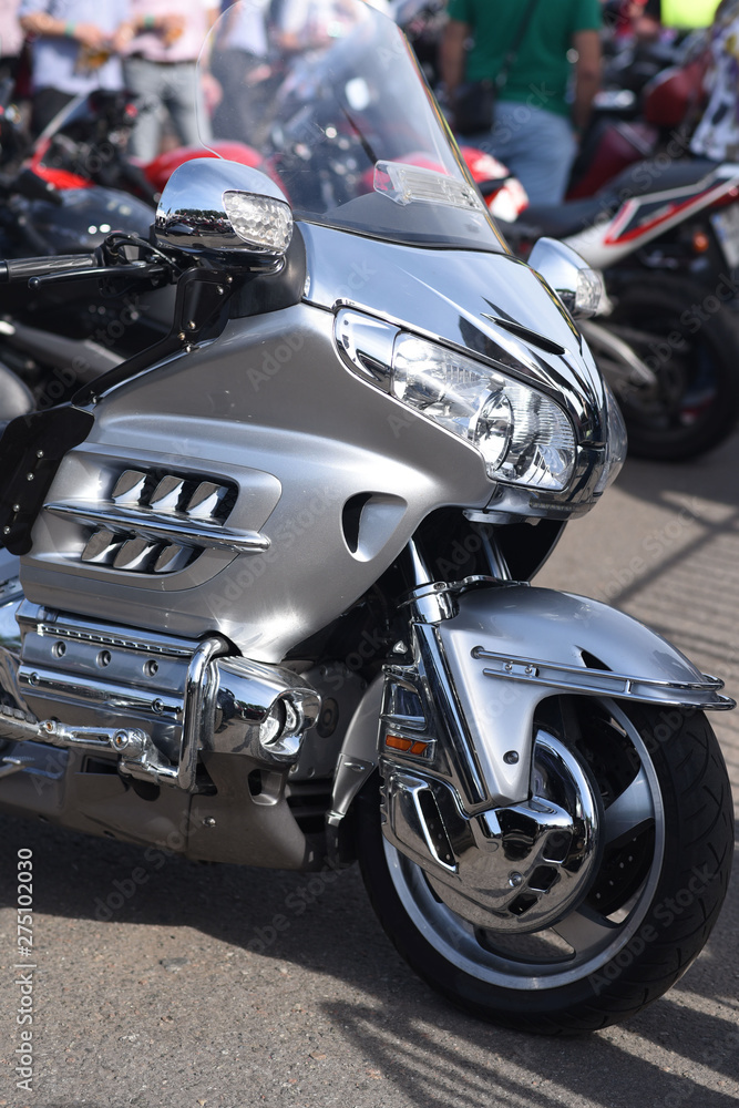 A motorbike on the show with chrome details and other parts, closeup with depth of field openair