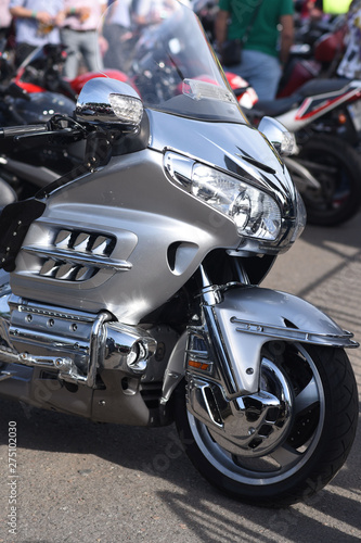 A motorbike on the show with chrome details and other parts  closeup with depth of field openair