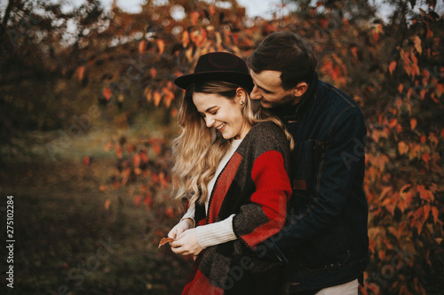 Young happy and smiling lovely couple embracing outdoor in park