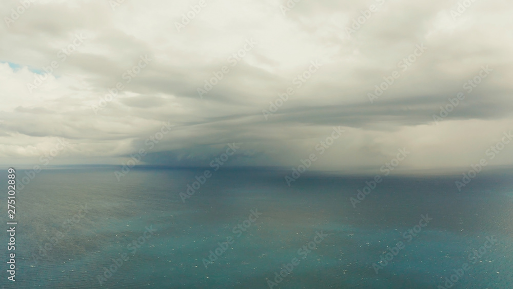 Fototapeta premium Seascape in cloudy weather, aerial view. Stormy weather over the ocean. Copy space for text. Water cloud horizon background.