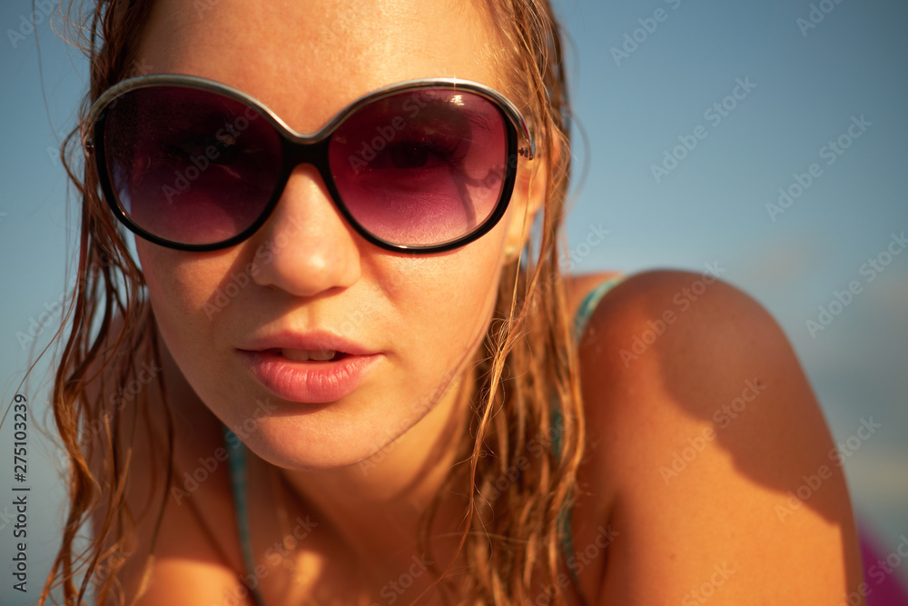 Closeup portrait of beautiful blond girl with wet hair in sunglasses Closeup portrait of beautiful blond girl with wet hair in sunglasses