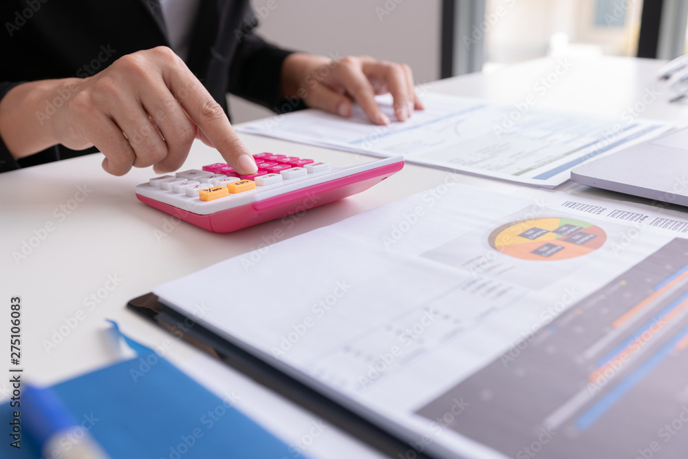 Businessman or Manager work with financial paper report, Close up accountant or banker making calculations. Savings,Concept finances and economy Businessman or Manager work with financial paper report, Close up accountant or banker making calculations. Savings,Concept finances and economy