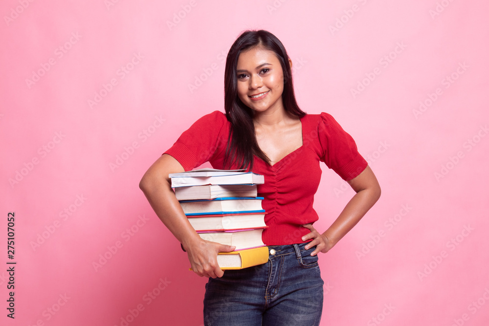 Young Asian woman studying with may books. Young Asian woman studying with may books.