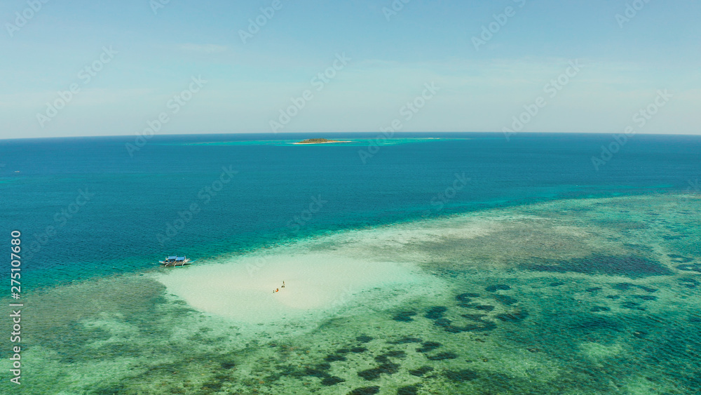 Sand bar among coral reefs in turquoise atoll water, top view. Summer and travel vacation concept. Balabac, Palawan, Philippines.