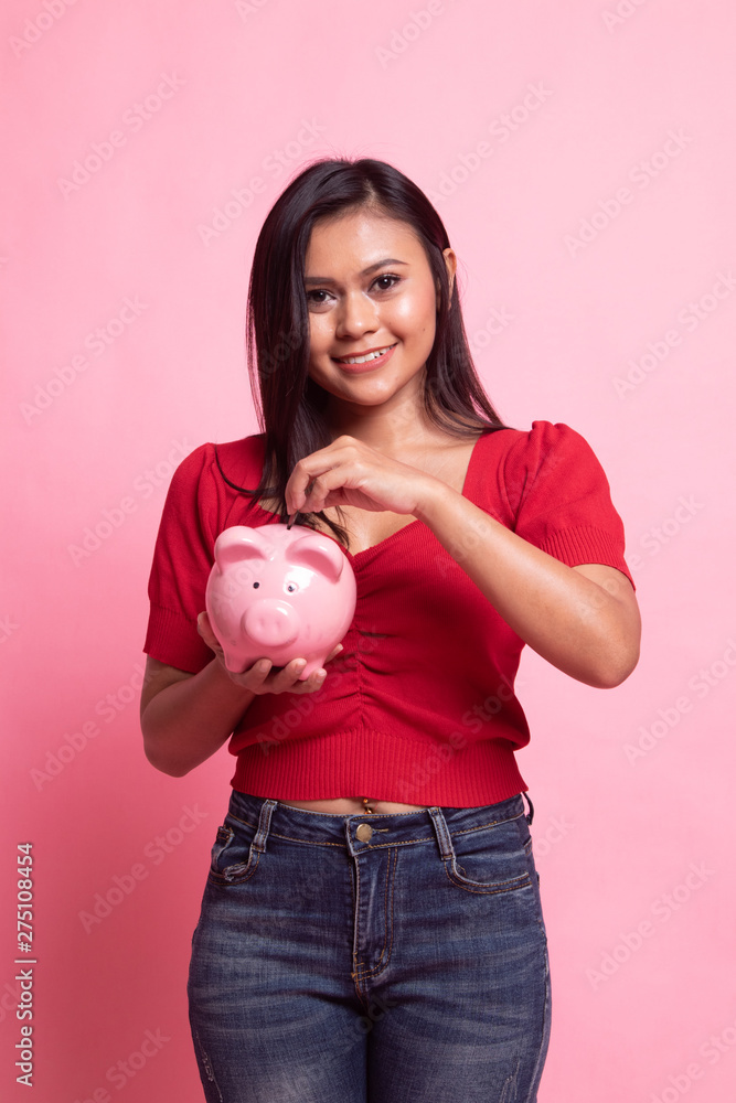 Asian woman with coin and pig coin bank. Asian woman with coin and pig coin bank.