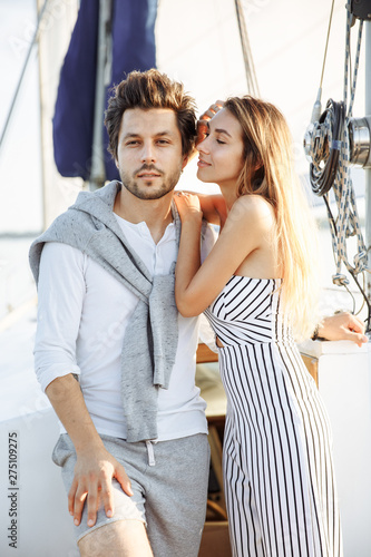 Beautiful couple walking on a yacht under sail © artist_09