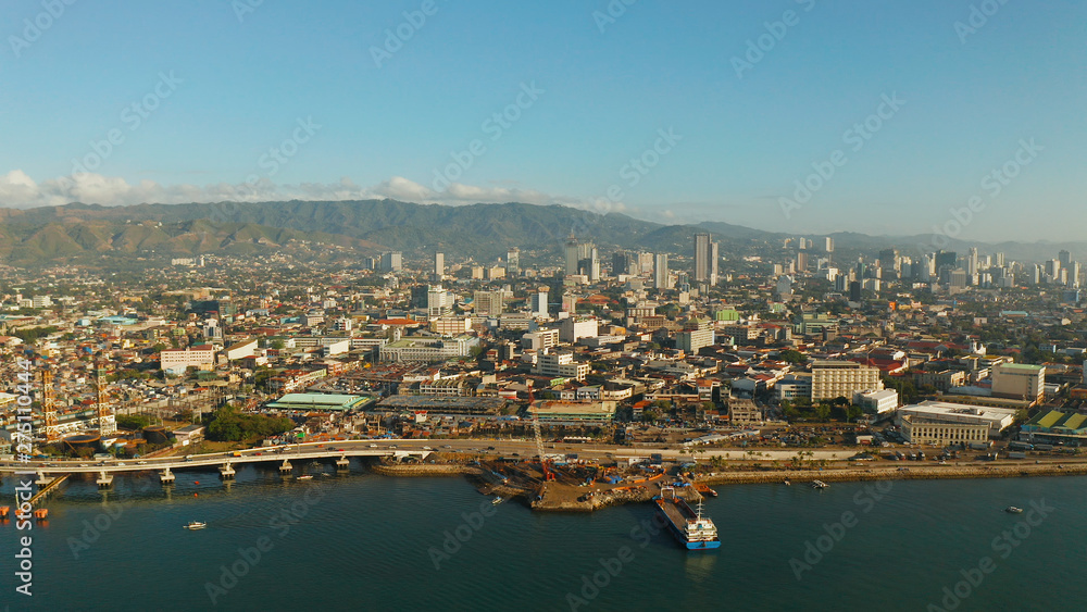 Aerial view of panorama of the city of Cebu with skyscrapers and buildings during sunrise. Philippines.