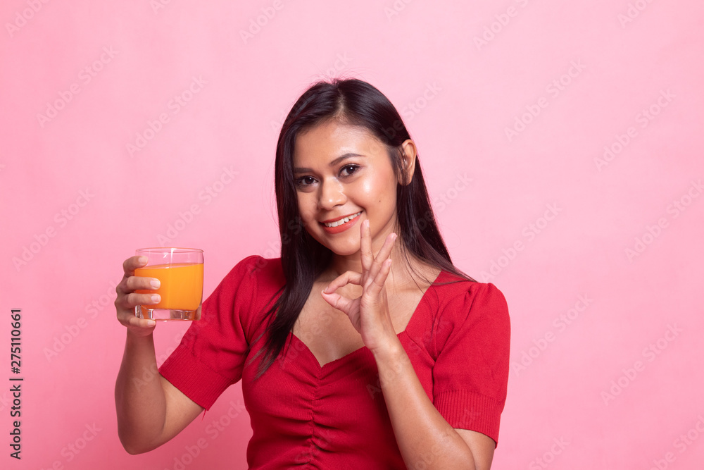 Young Asian woman show OK drink orange juice. Young Asian woman show OK drink orange juice.