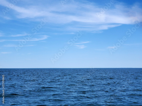 calm Lake Michigan blue water with horizon and summer sky