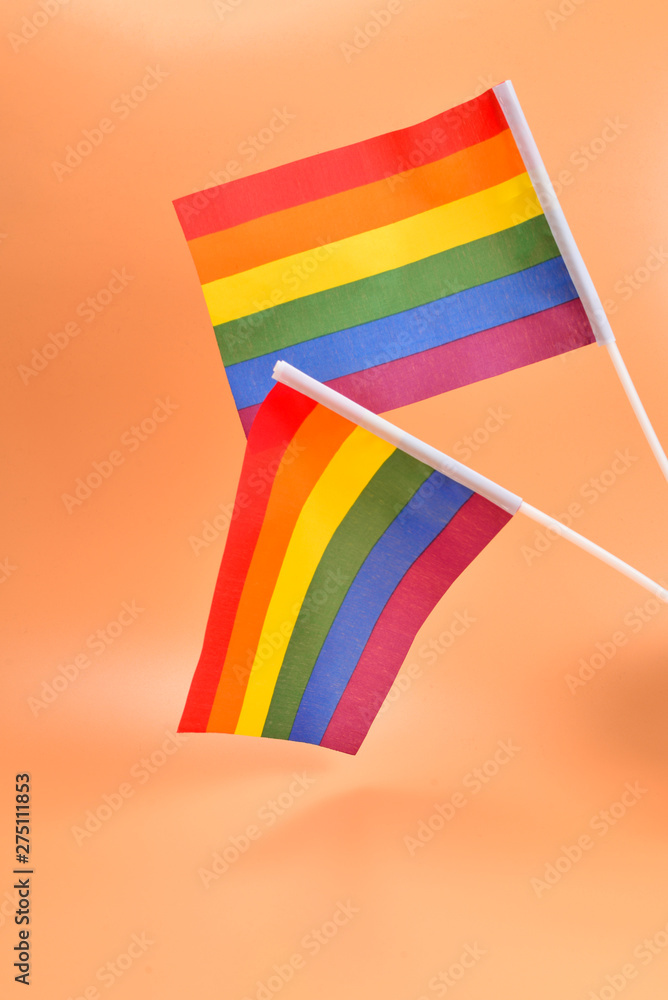 Fototapeta premium LGBT flag on orange background. Copy space.