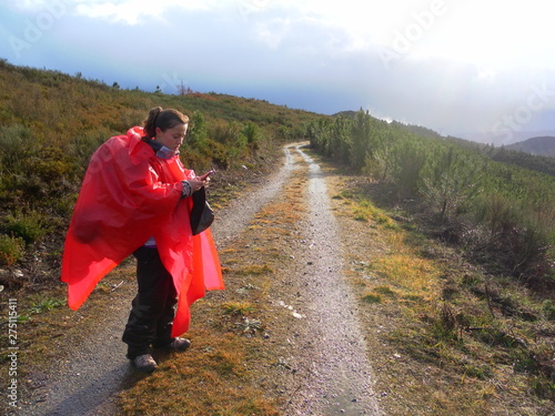 lost girl doing the road of santiago in rain day. photo