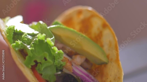 Preparing Mexican Burrito Food. Placing products in tortillas