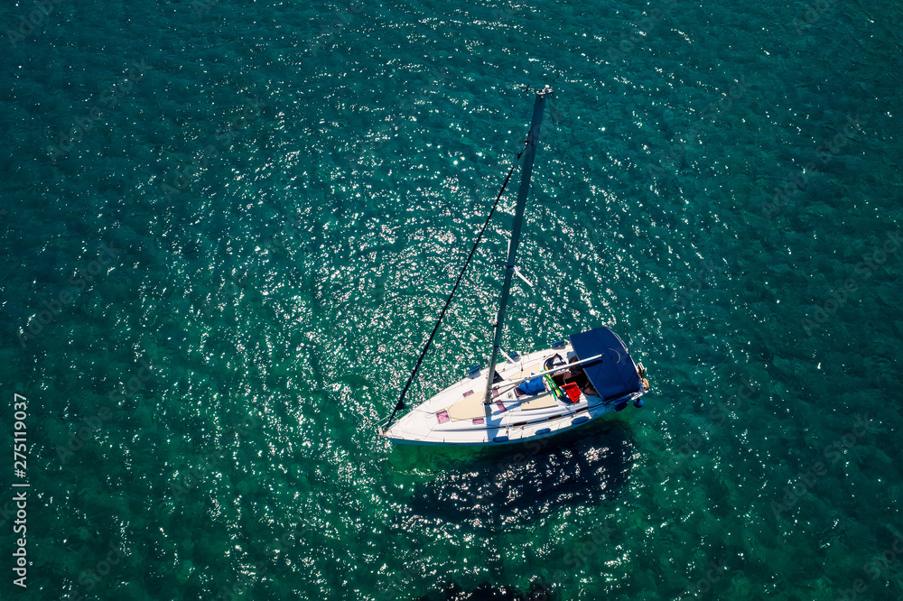 Top view of a boat sailing at the ocean at Chalkidiki, Greece. Aerial Photography.
