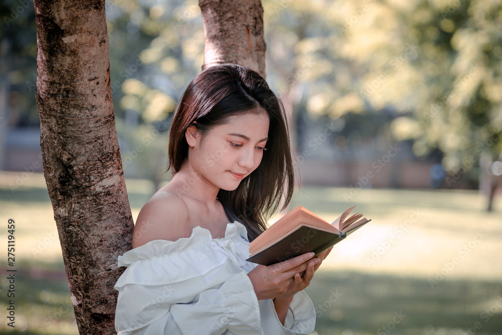 Naklejka premium One women in Public park drink coffee and read a book