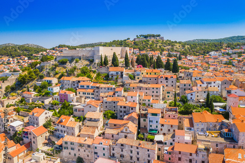 Croatia, city of Sibenik, panoramic view of the old town center, houses on hills and old fortress of St Michael over the city