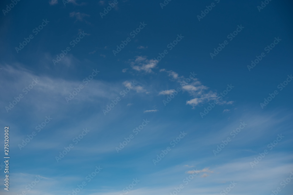 white cirrus clouds against a blue sky