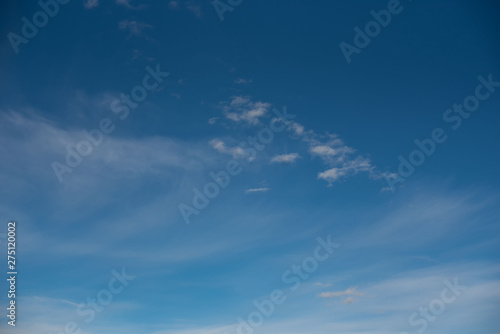 white cirrus clouds against a blue sky