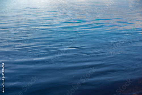 blue water surface as a background. waves on the surface of the water