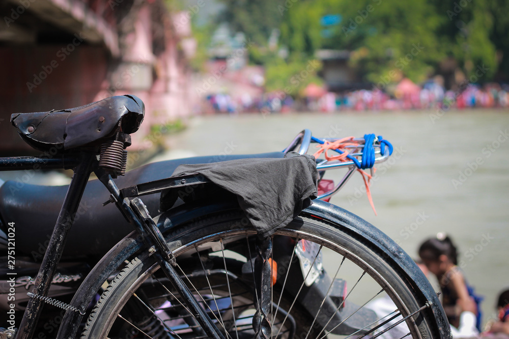 Fototapeta premium old bicycle standing on a ganga ghat Haridwar Uttarakhand