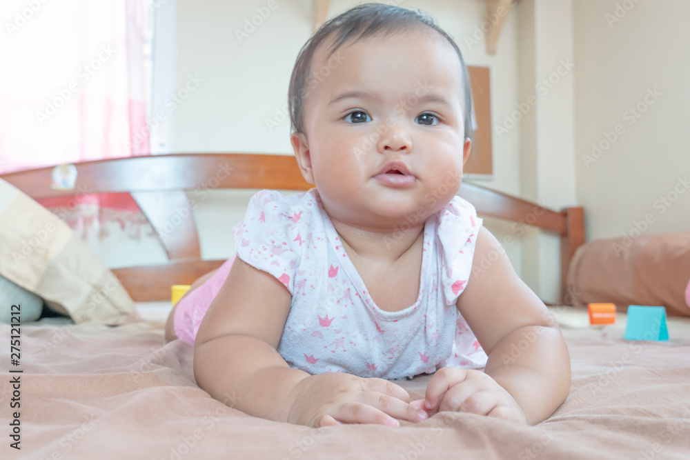 Asian baby girl lying down on the bed Asian baby girl lying down on the bed