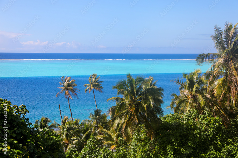 View of the layers of blue in the ocean from an island in Tahiti. 