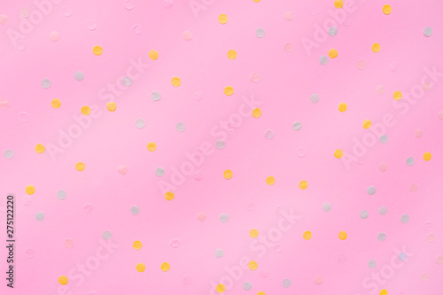 Pink pastel festive background with multicolored confetti. Copy space for your text. Flat lay style. Top view. 