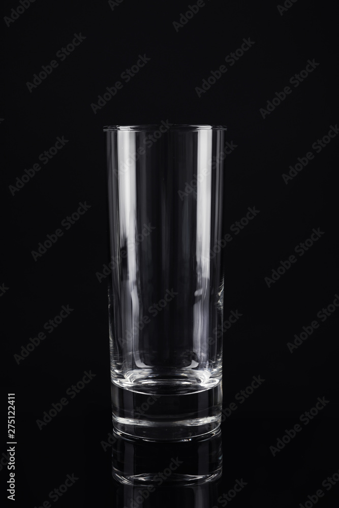 New empty tall glass on black background New empty tall glass on black background