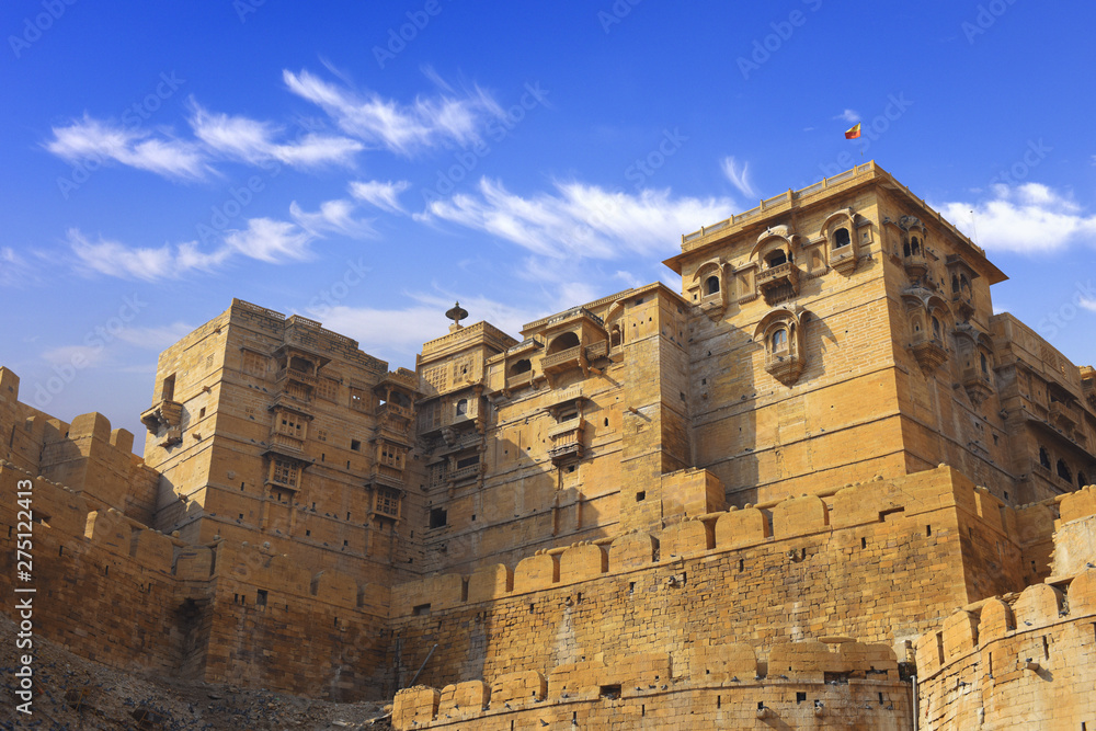 towers of historical Jaisalmer fort with monumental stone walls in old desert Thar city, Rajasthan, India 