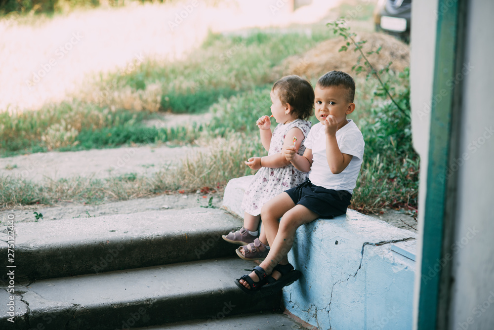 Cute kids eating candy outdoors in the summer very nice Cute kids eating candy outdoors in the summer very nice