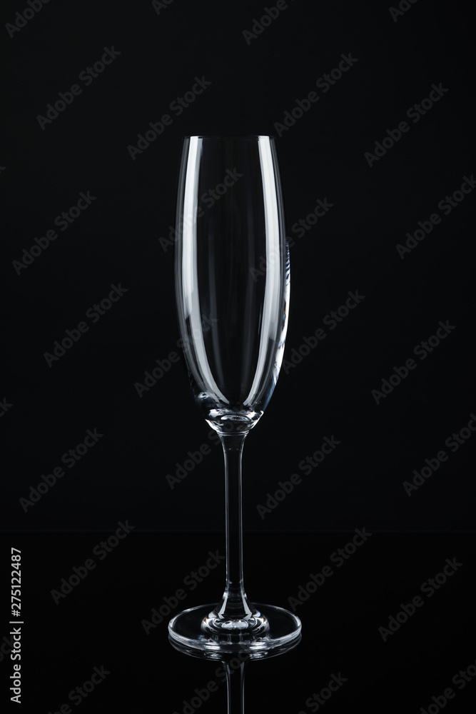 New empty champagne glass on black background New empty champagne glass on black background