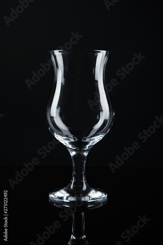 Clean empty cocktail glass on black background