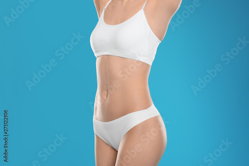 Slim young woman with smooth gentle skin on color background. Beauty and body care concept