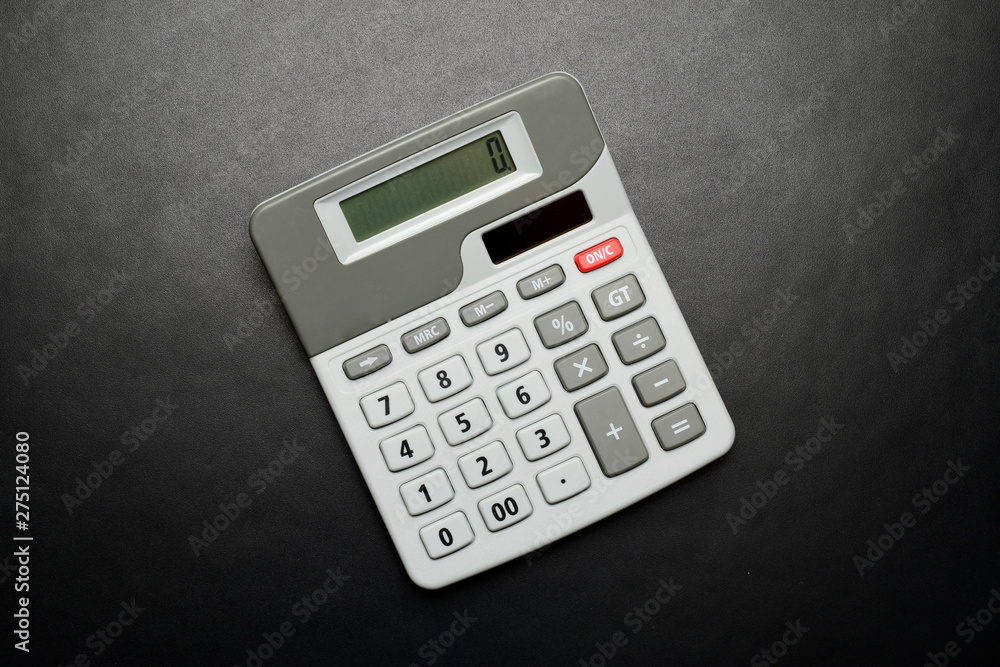 calculator on black background with copyspace, top view calculator on black background with copyspace, top view