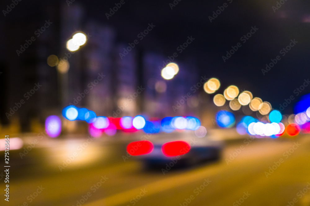 Abstract blurred background of night city.Night traffic,colorful lights
