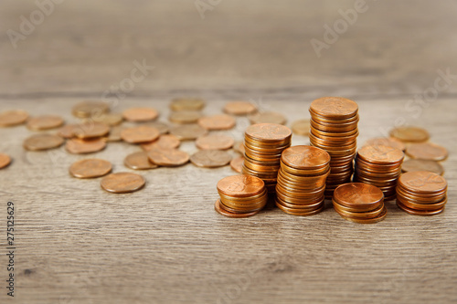 Many coins on wooden table, space for text