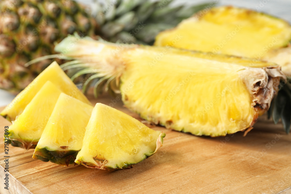 Cut fresh juicy pineapple on wooden board, closeup Cut fresh juicy pineapple on wooden board, closeup