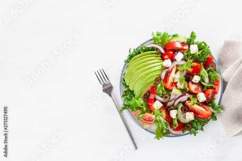 greek style avocado tomato salad with feta cheese, olives, cucumber, onion, lettuce