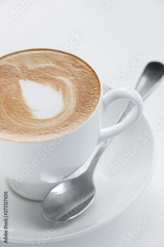 Cappuccino, Cafe latte, cafe con leche, melange or Flat White coffee depending on where you are in the world. Close up shot isolated on a white background. The  perfect drink to start the day. photo