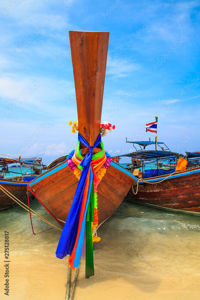 Long tailed boat at  kho lipe satun Thailand/Fishing boat on the sea and blue sky background at  kho lipe satun Thailand/Tropical beach kho lipe satun Thailand wooden long tailed boat on the sea/ 