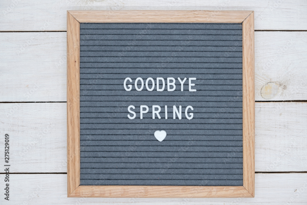 English text goodbye spring on a letter Board in white letters on a gray background and a symbol of heart