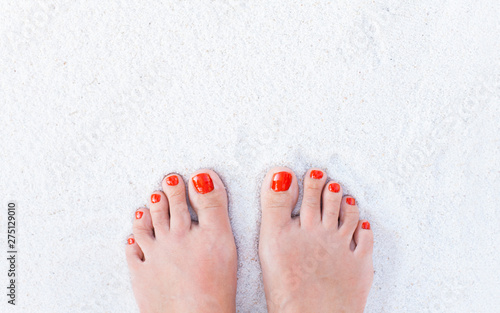 Female feet on sand